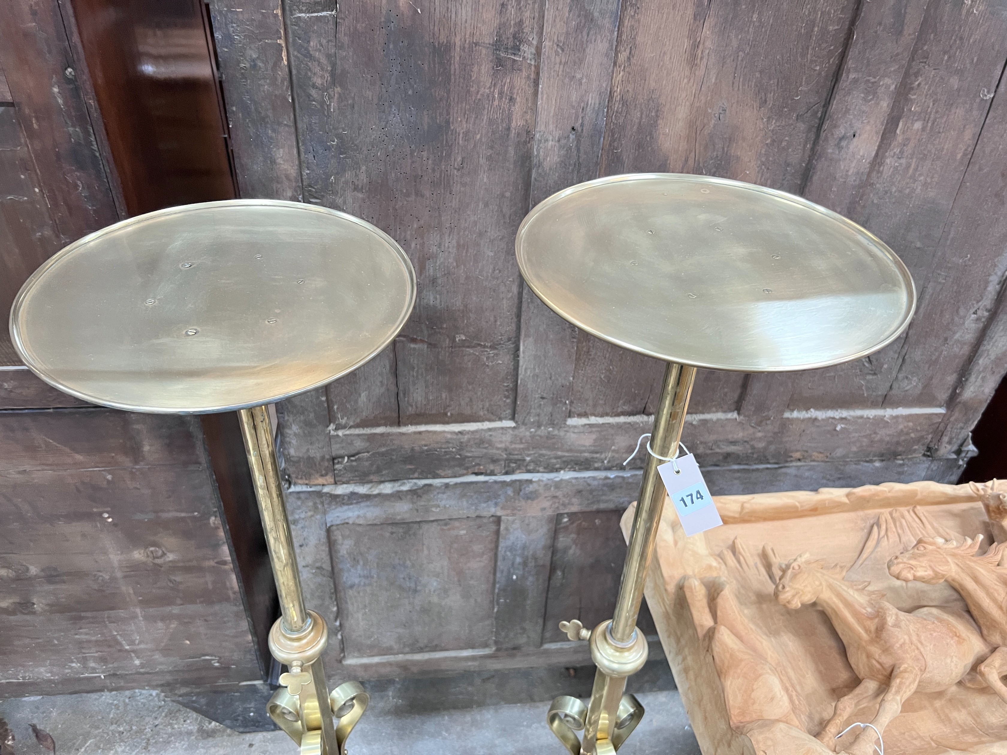 A pair of ecclesiastical brass telescopic candle stands, maximum height 135cm *Please note the sale commences at 9am.